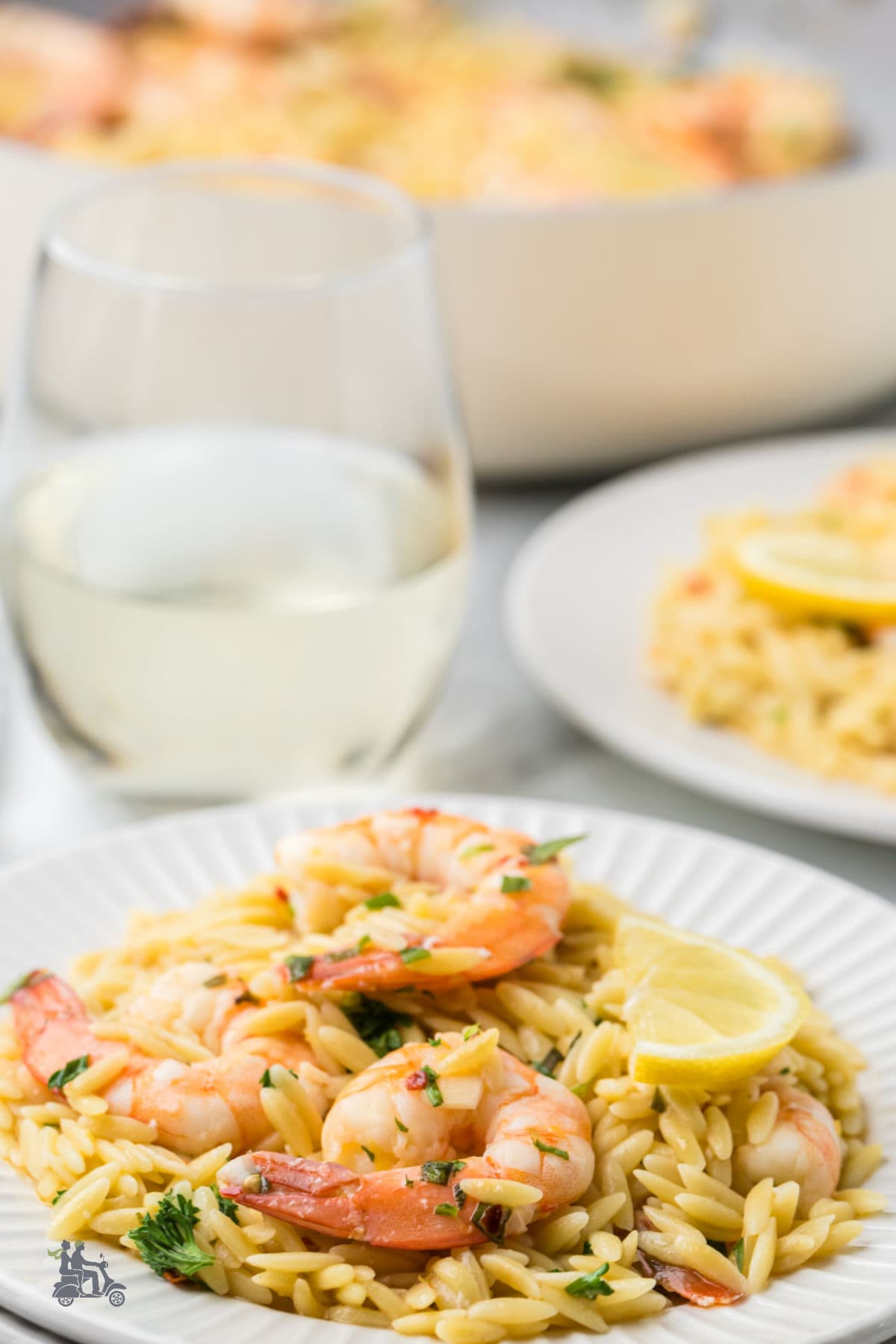 A spring and summer type shrimp pasta dish with orzo pasta seasoned with fresh herbs and citrus. 
