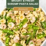 A Pinterest image with a title overlay for the zesty shrimp pasta salad with snap peas and herbs.
