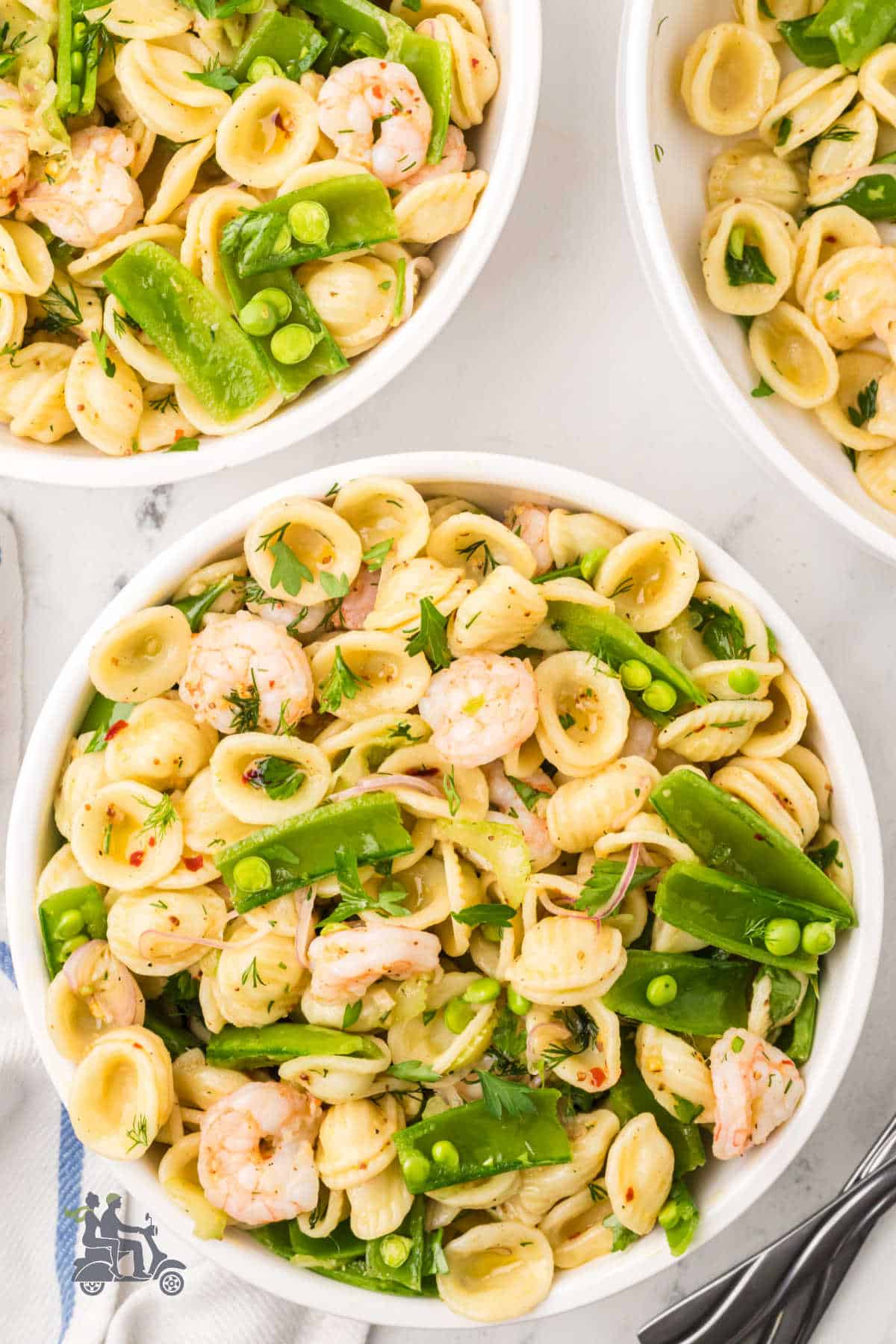 Zesty shrimp pasta salad with sugar snap peas for spring and summer meals.