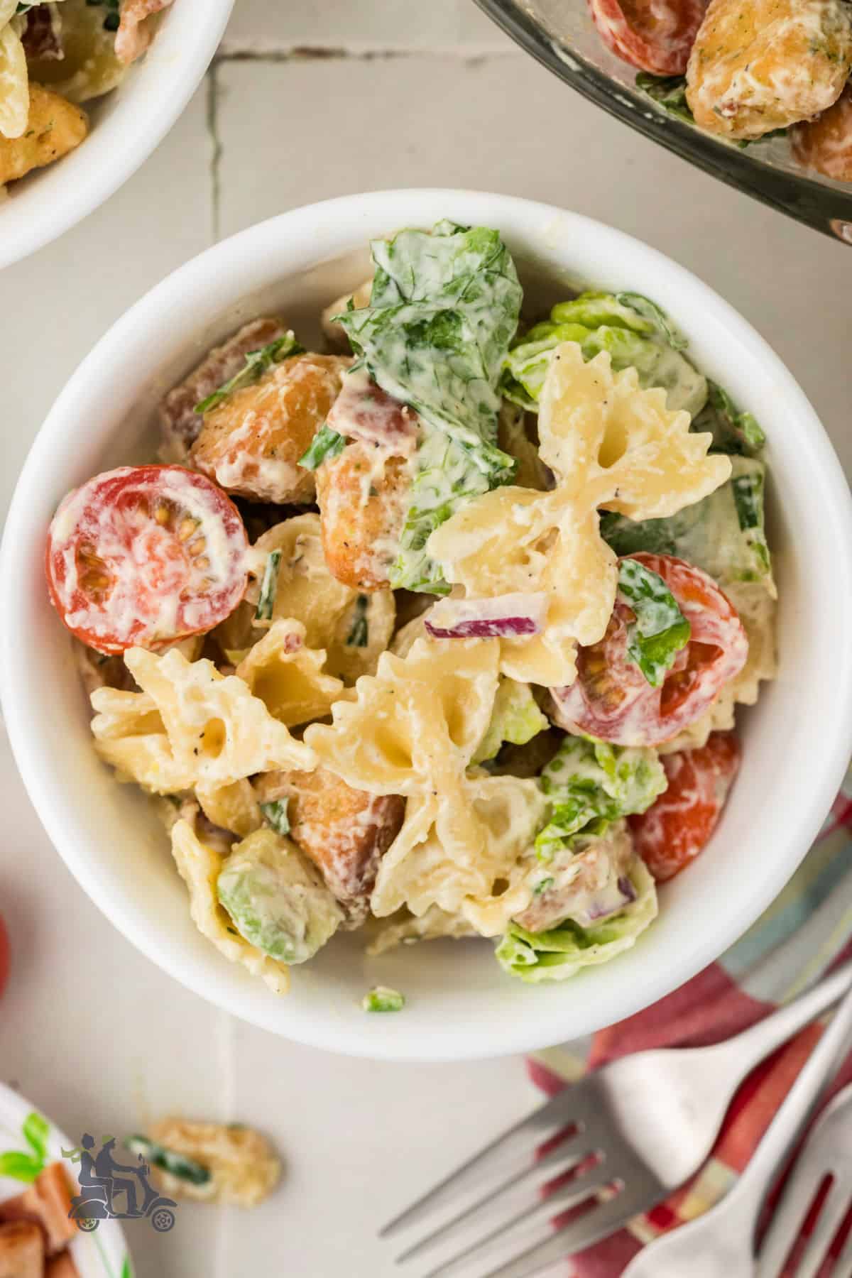 Overhead view or the mustard ranch dressed bow tie pasta salad with all the flavors of a BLT sandwich. 