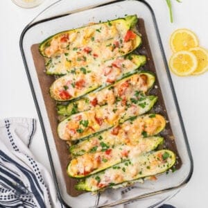 Overhead view of the creamy shrimp zucchini stuffed boats in a casserole dish.