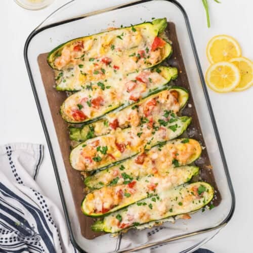 Overhead view of the creamy shrimp zucchini stuffed boats in a casserole dish.