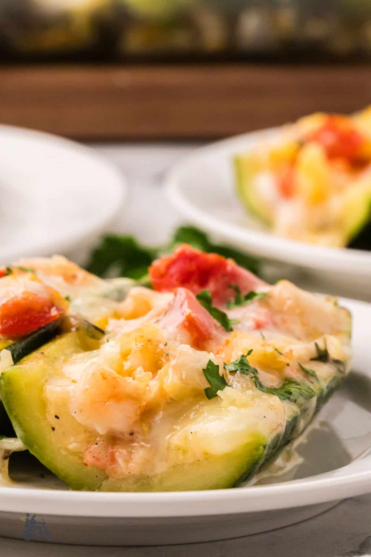 Low-carb zucchini boats filled with shrimp in a tomato cheese sauce.