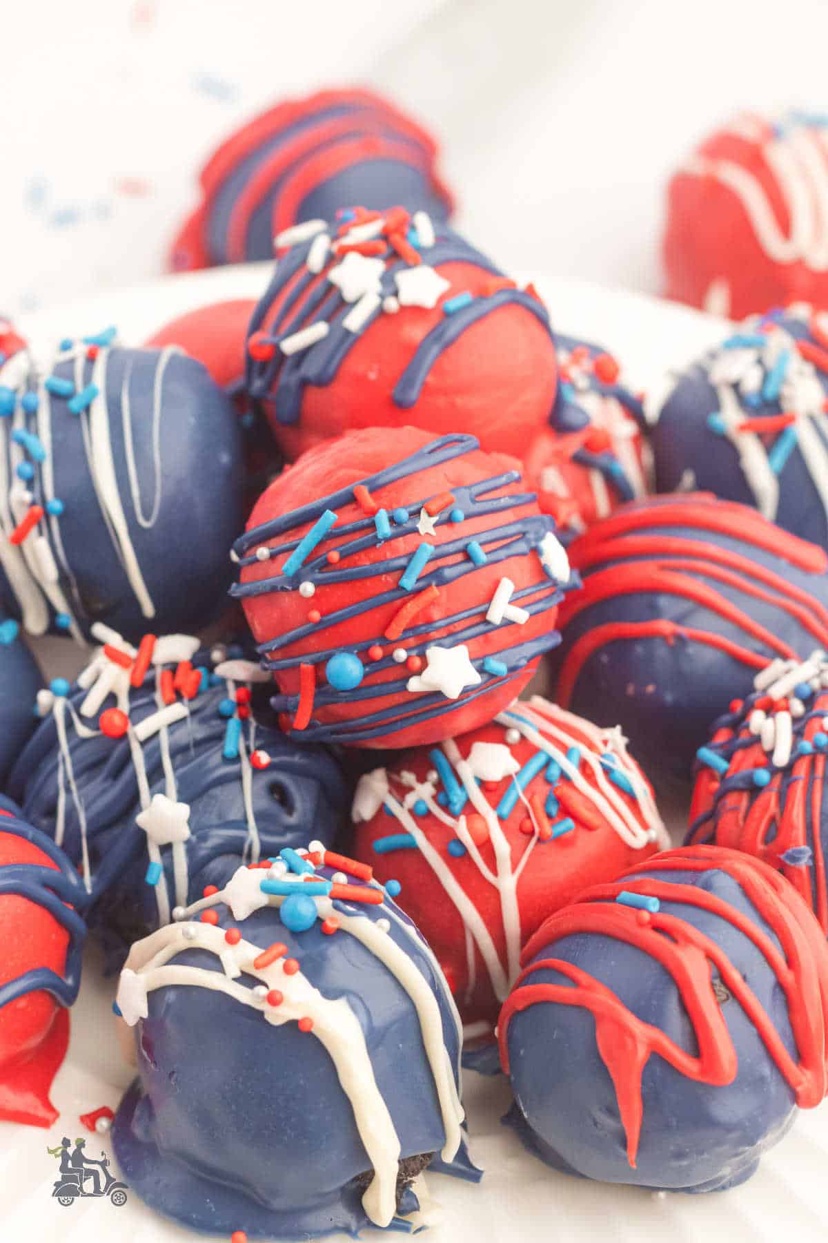 Make ahead patriotic treats using crushed oreo cookies and rolled with softened cream cheese.