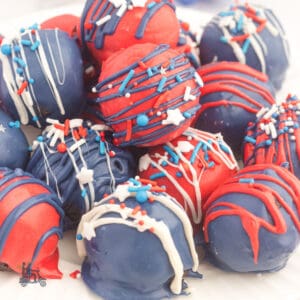 Piles of red, white, and blue oreo truffle balls decorated with patriotic sprinkles.