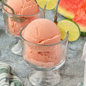 Easy Watermelon ice cream in glass goblets with lime on the glass rim.