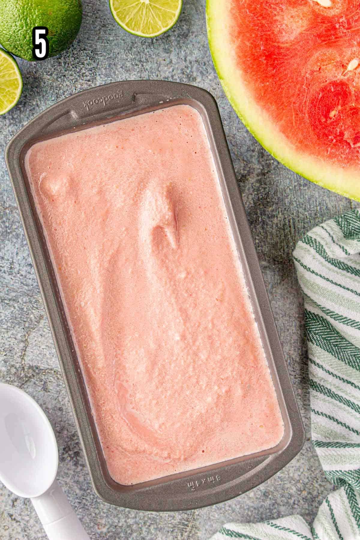 The final step to making the no-churn melon ice cream is to transfer it to a container and freeze.