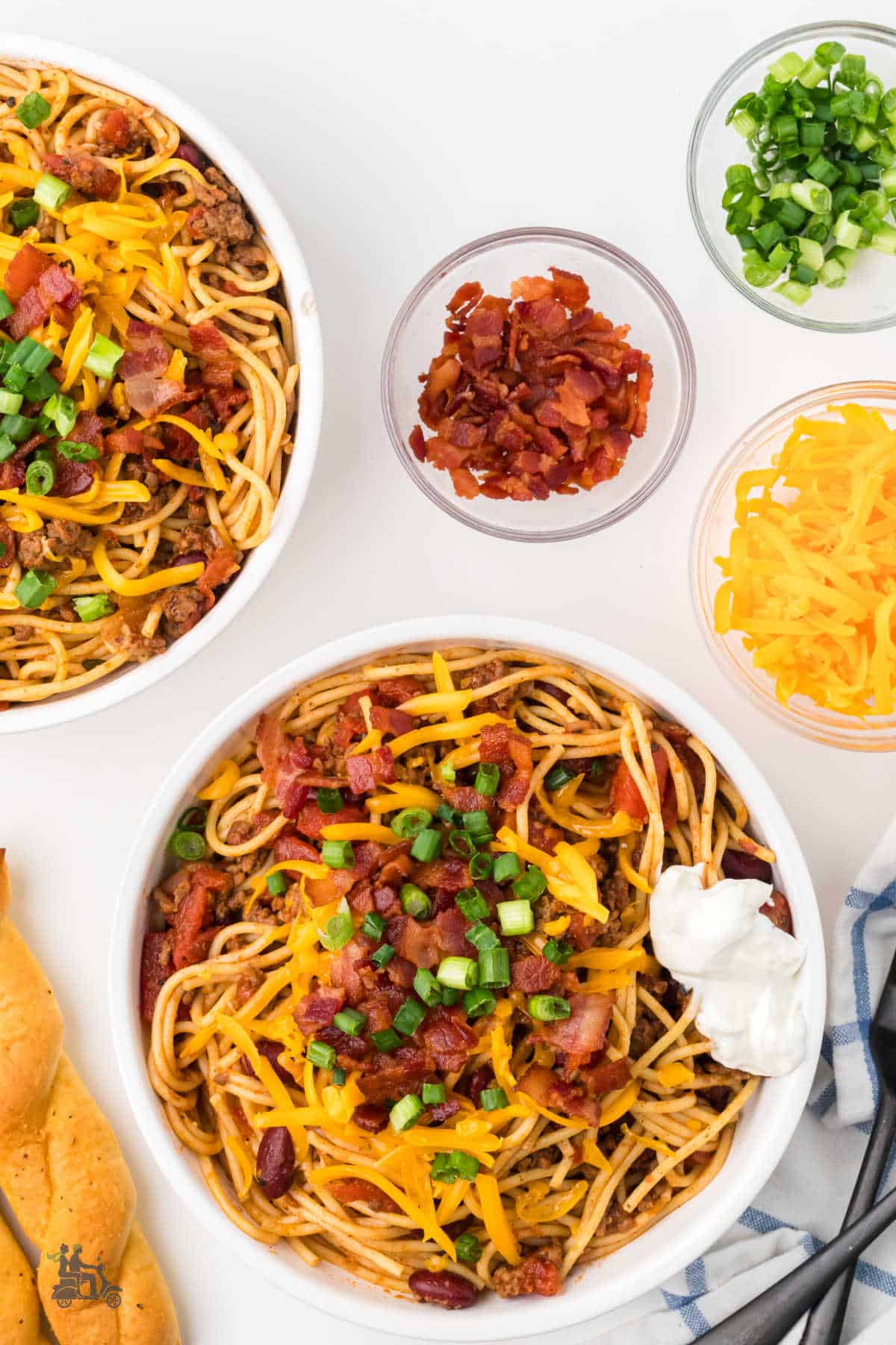 Overhead shot of cheesy Cowboy Spaghetti with bacon and beef.