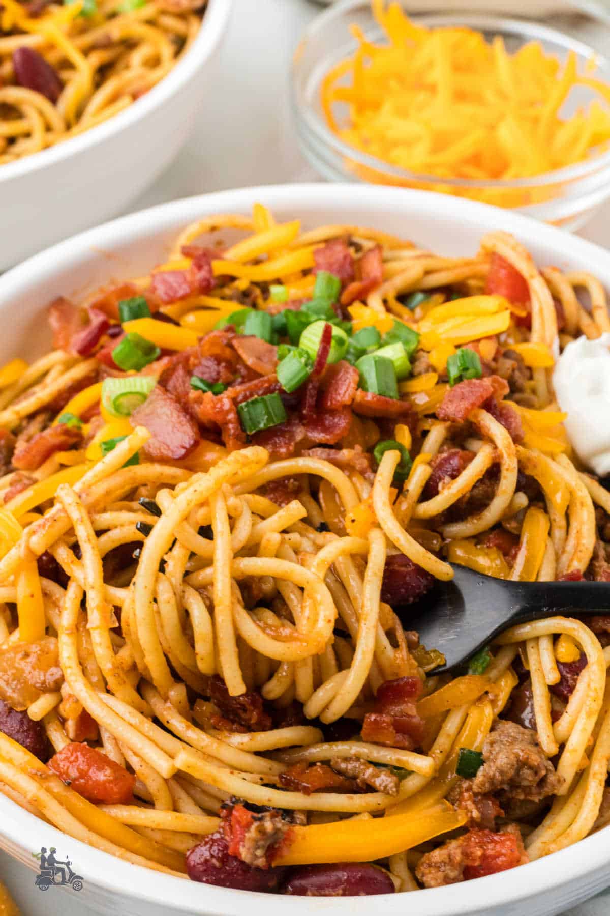 Fork twirling smoky cheesy Cowboy spaghetti dinner.