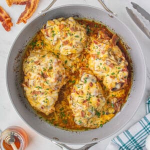Four chicken breasts in a deep skillet made in the copycat Alice Springs recipe.