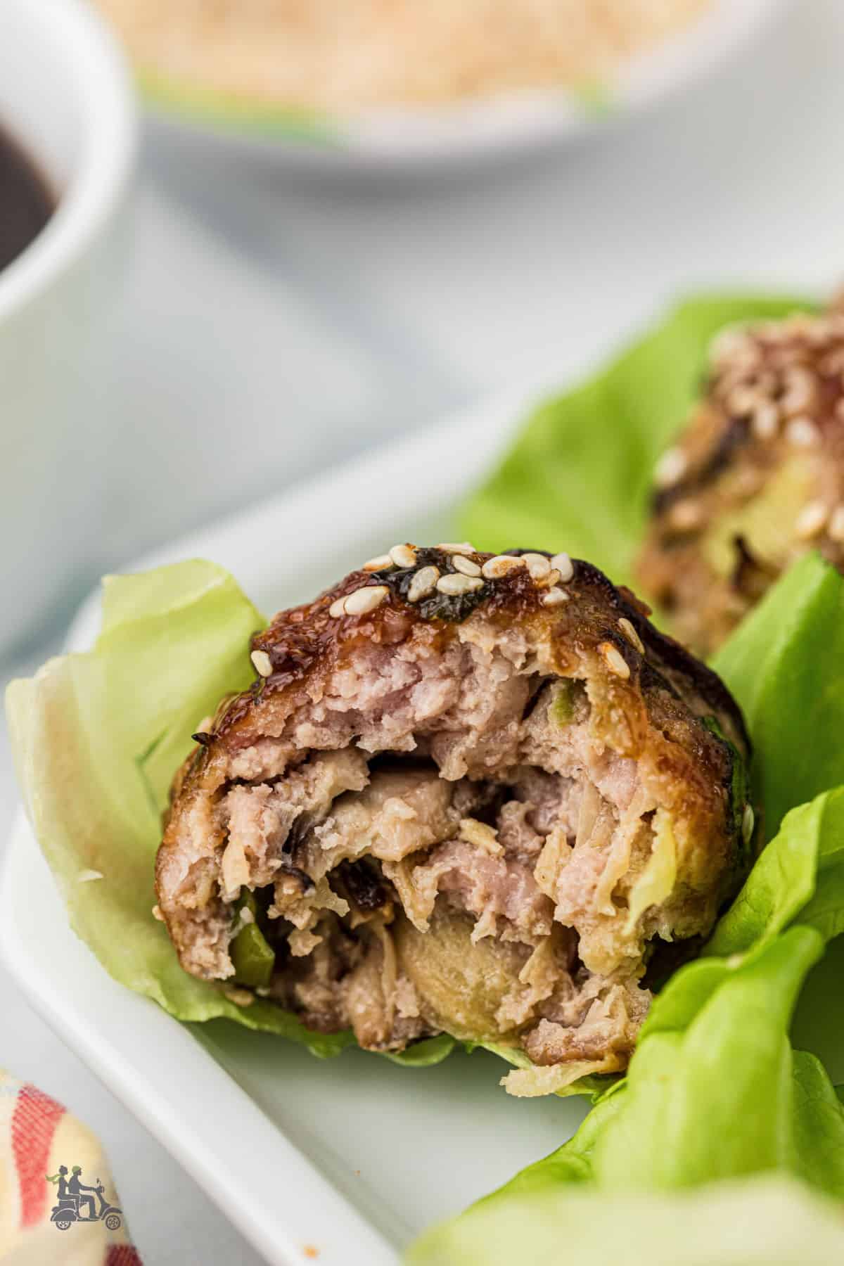 An Asian Pork meatball, split in half, showcases a light yet flavorful appetizer. 
