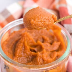 A jelly jar filled with homemade pumpkin butter spread.