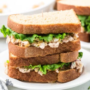 Easy Mediterranean chickpea and tuna salad sandwich served on whole wheat bread.