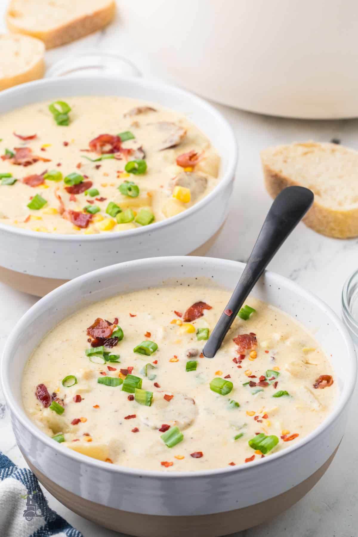 Close-up of spicy corn chowder with fresh corn, potatoes, and crispy bacon. 