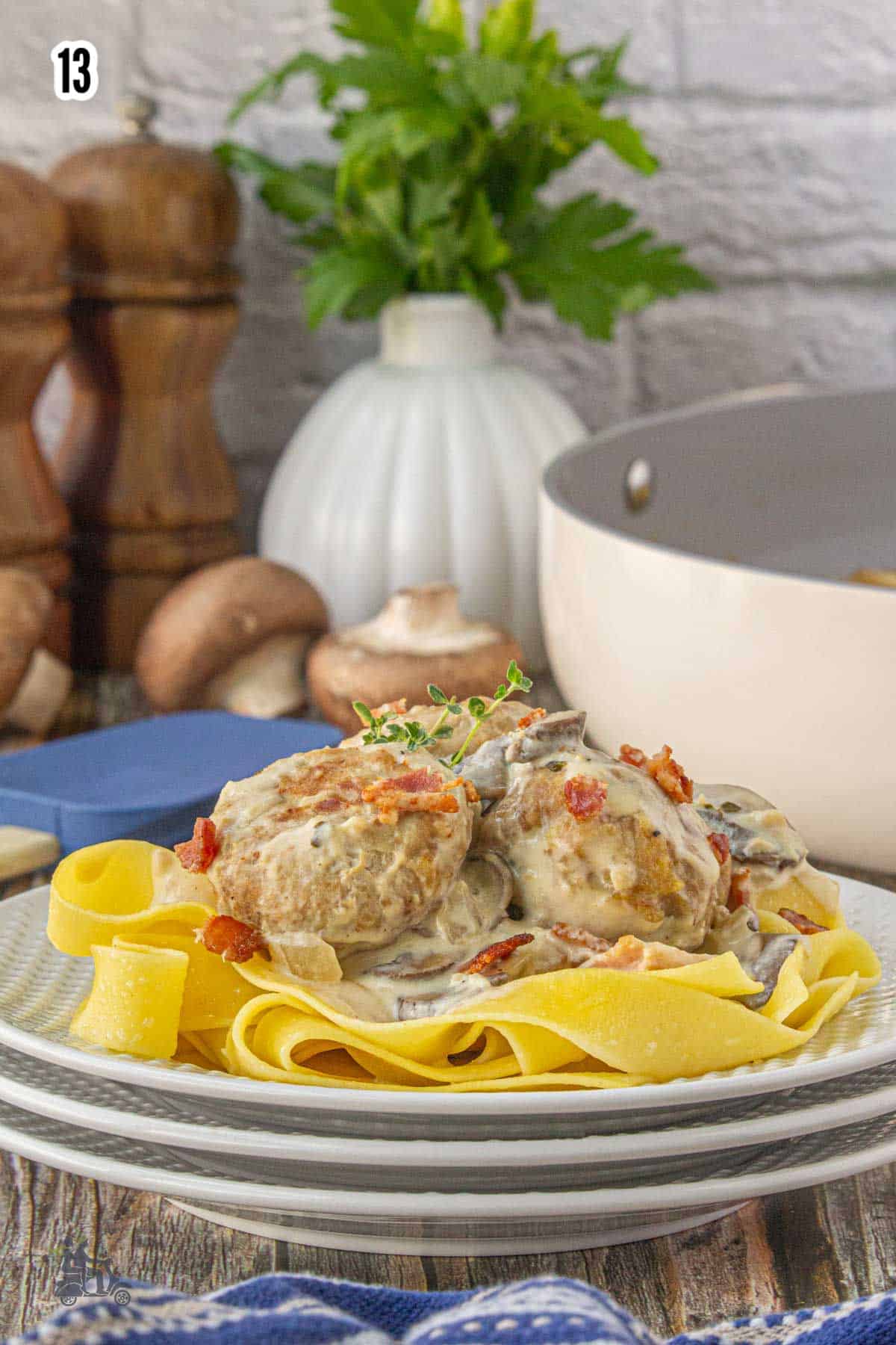Step thirteen shows the completed Coq au Vin Blanc Turkey Meatball recipe served over Tagliatelle egg pasta. 