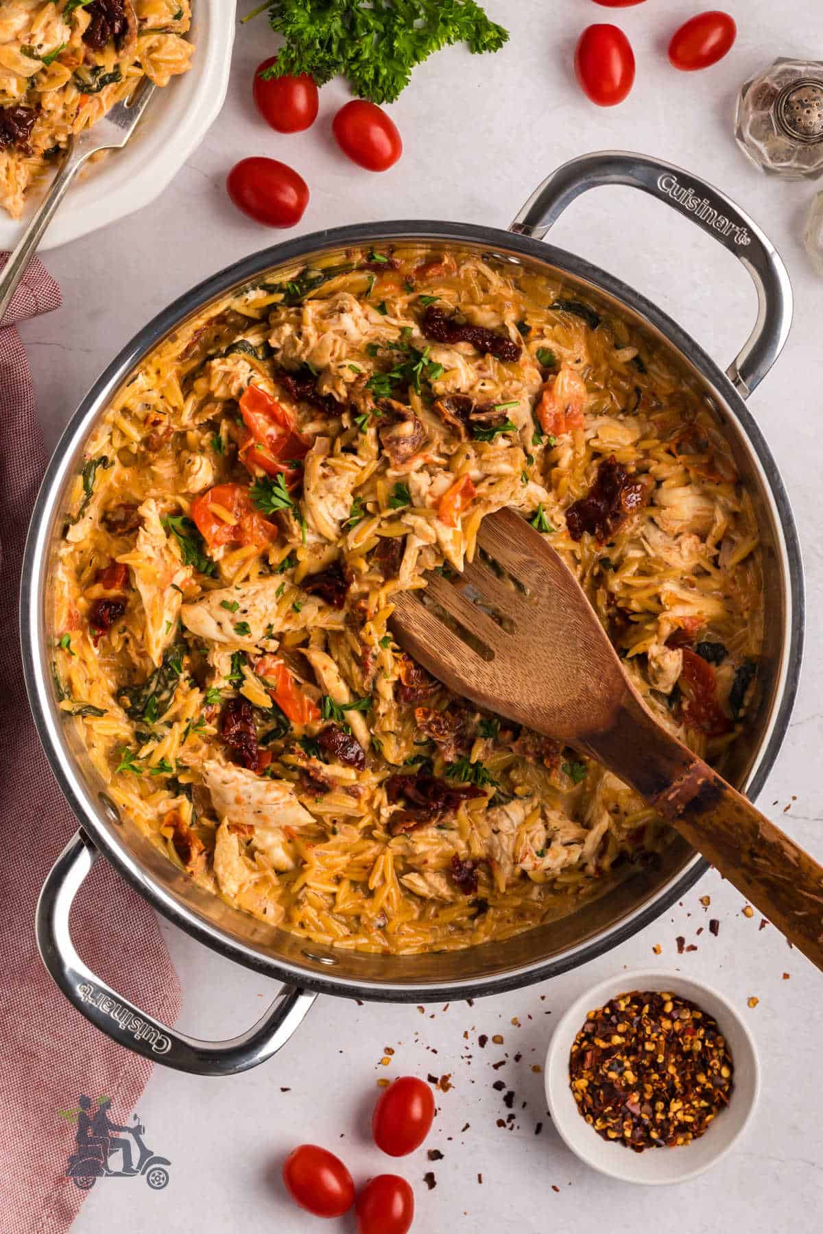 Overhead view of creamy Tuscan chicken pasta with orzo and parmesan cheese. 