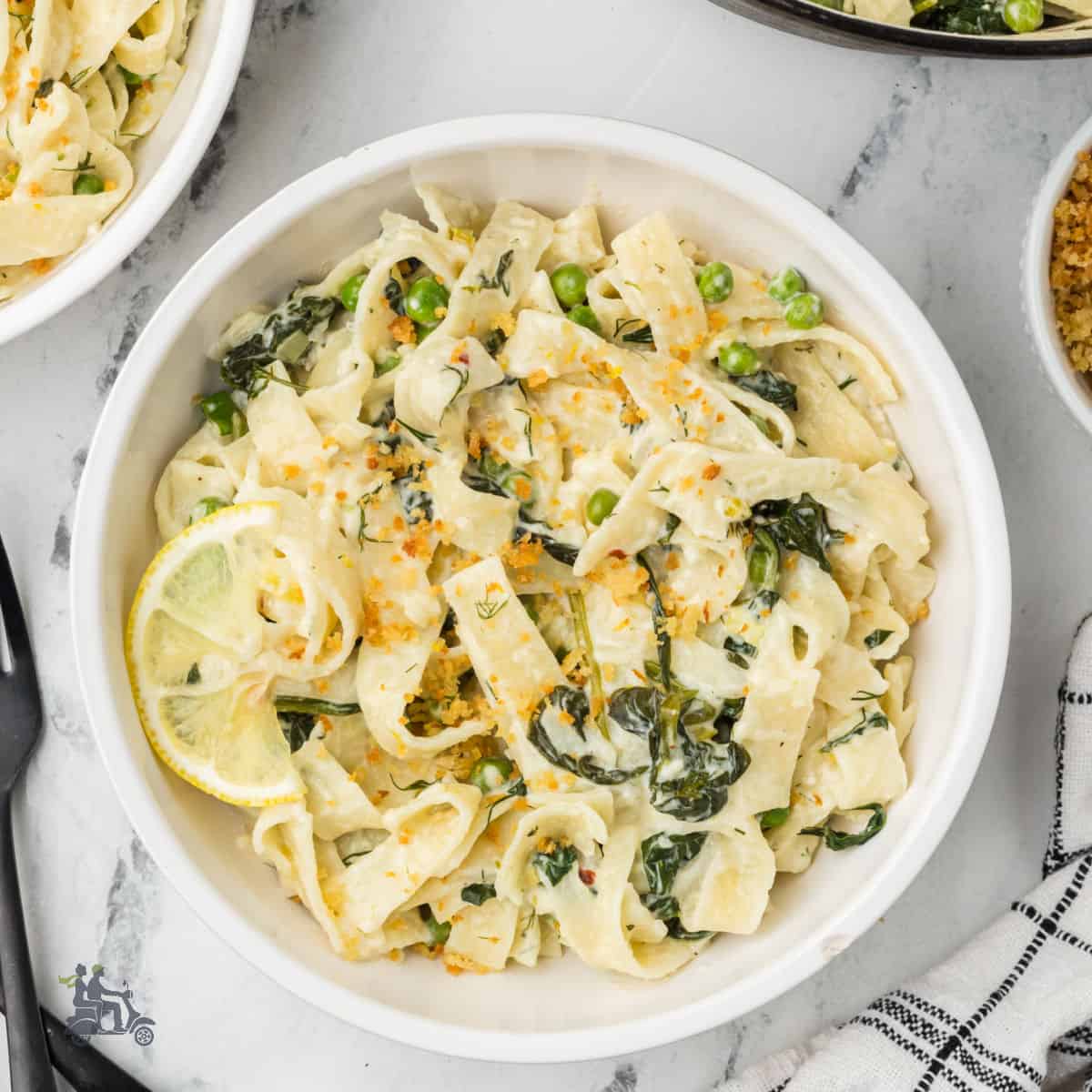 Greek-inspired creamy tagliatelle pasta with spinach, lemon, and feta cheese.