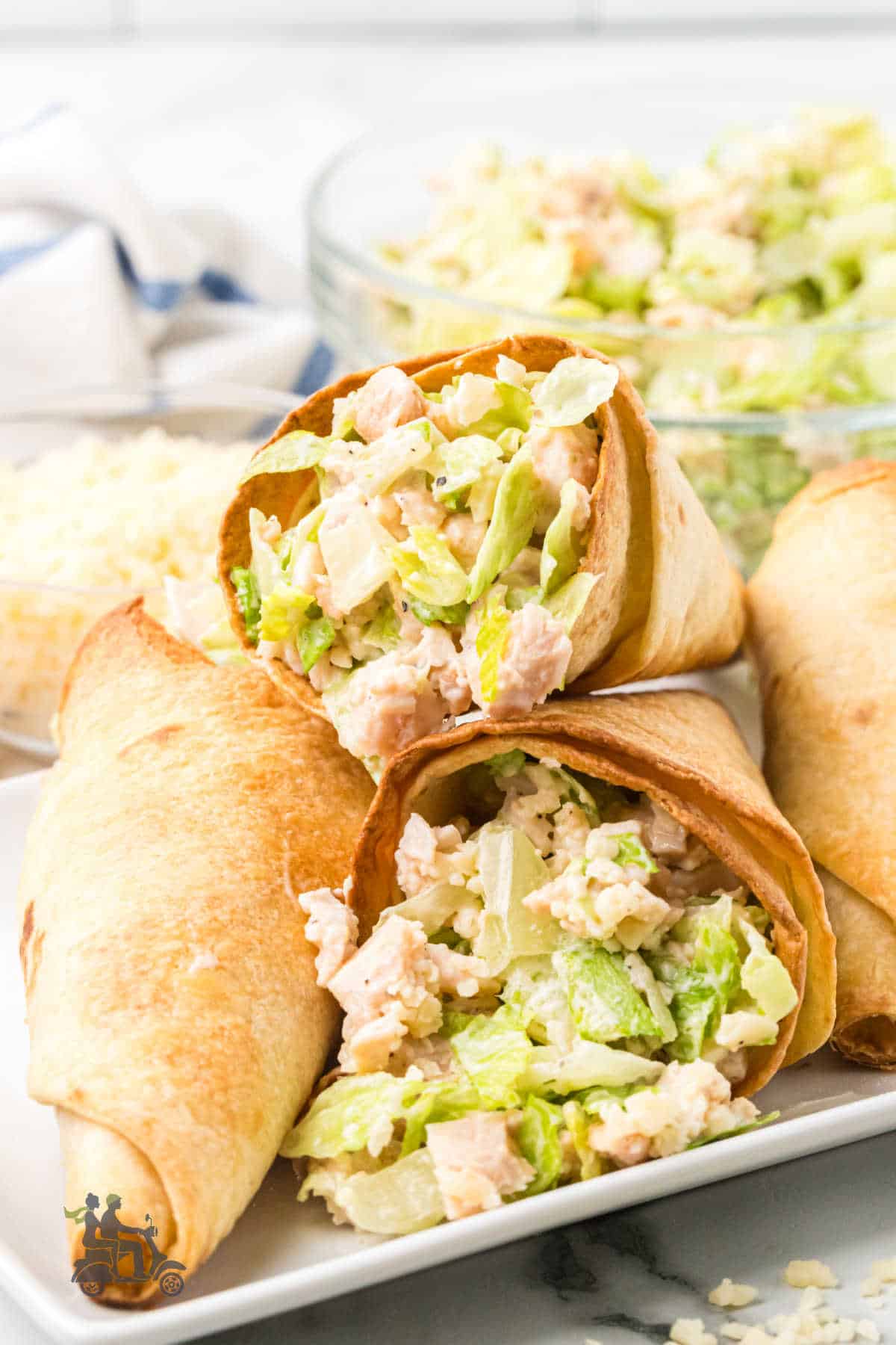 Caesar salad in a tortilla cones on a plate.