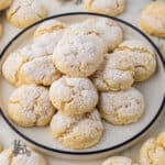 Yellow cake mix cookies made with butter and cream cheese and sprinkled with confectioners' sugar.