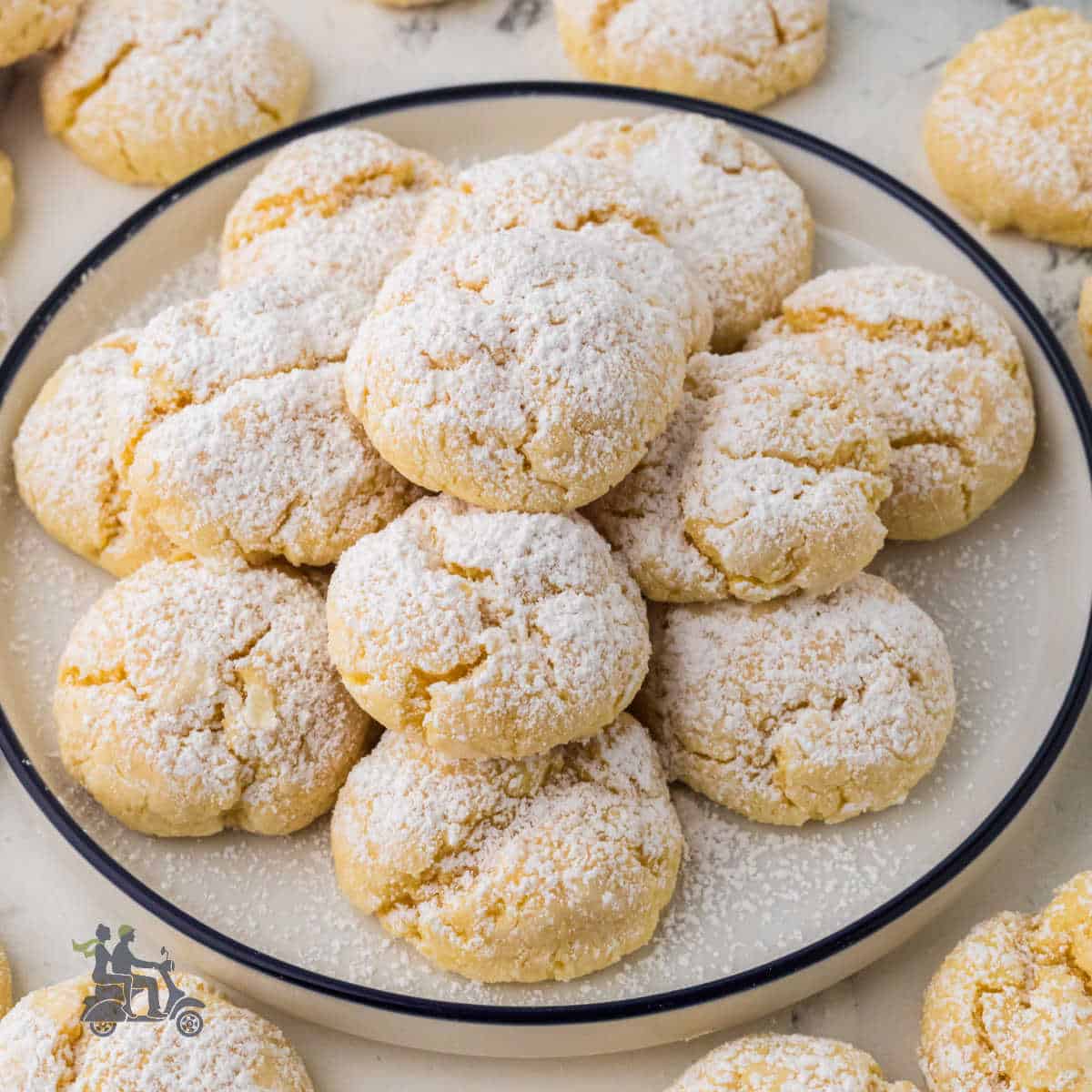Yellow cake mix cookies made with butter and cream cheese and sprinkled with confectioners' sugar.
