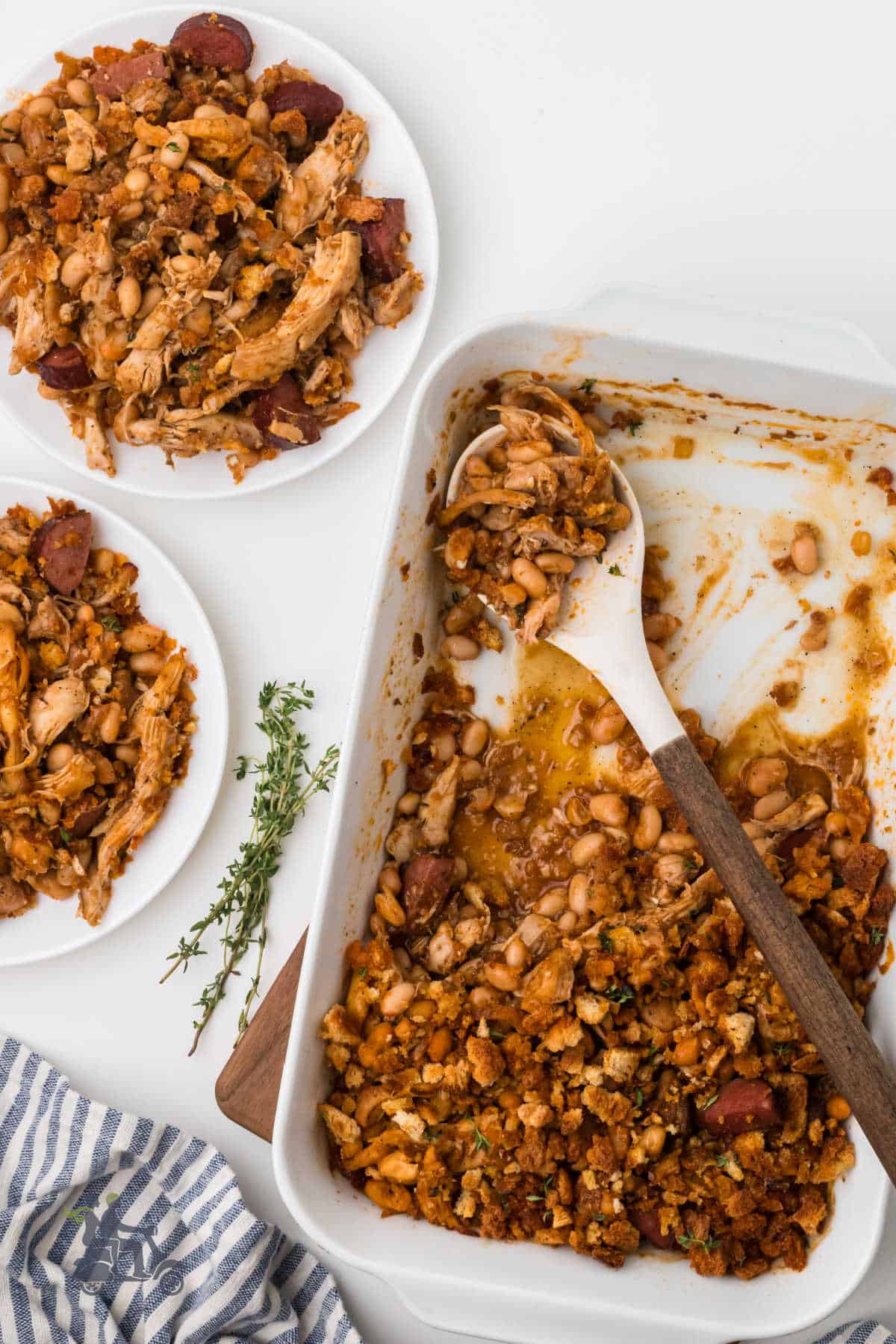 French Chicken casserole with sausage on a table with servings on two plates. 