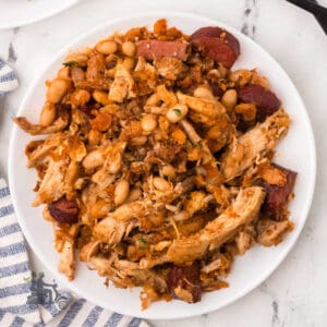 A quick and hearty French cassoulet with white beans and thyme on a white serving plate.