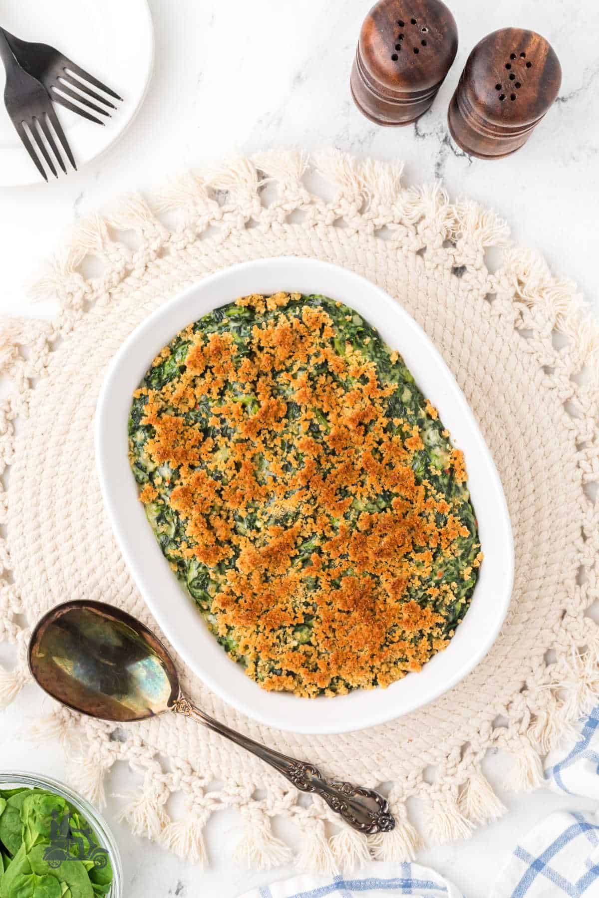Creamy Spinach Casserole topped with buttery Italian breadcrumbs on the holiday table. 