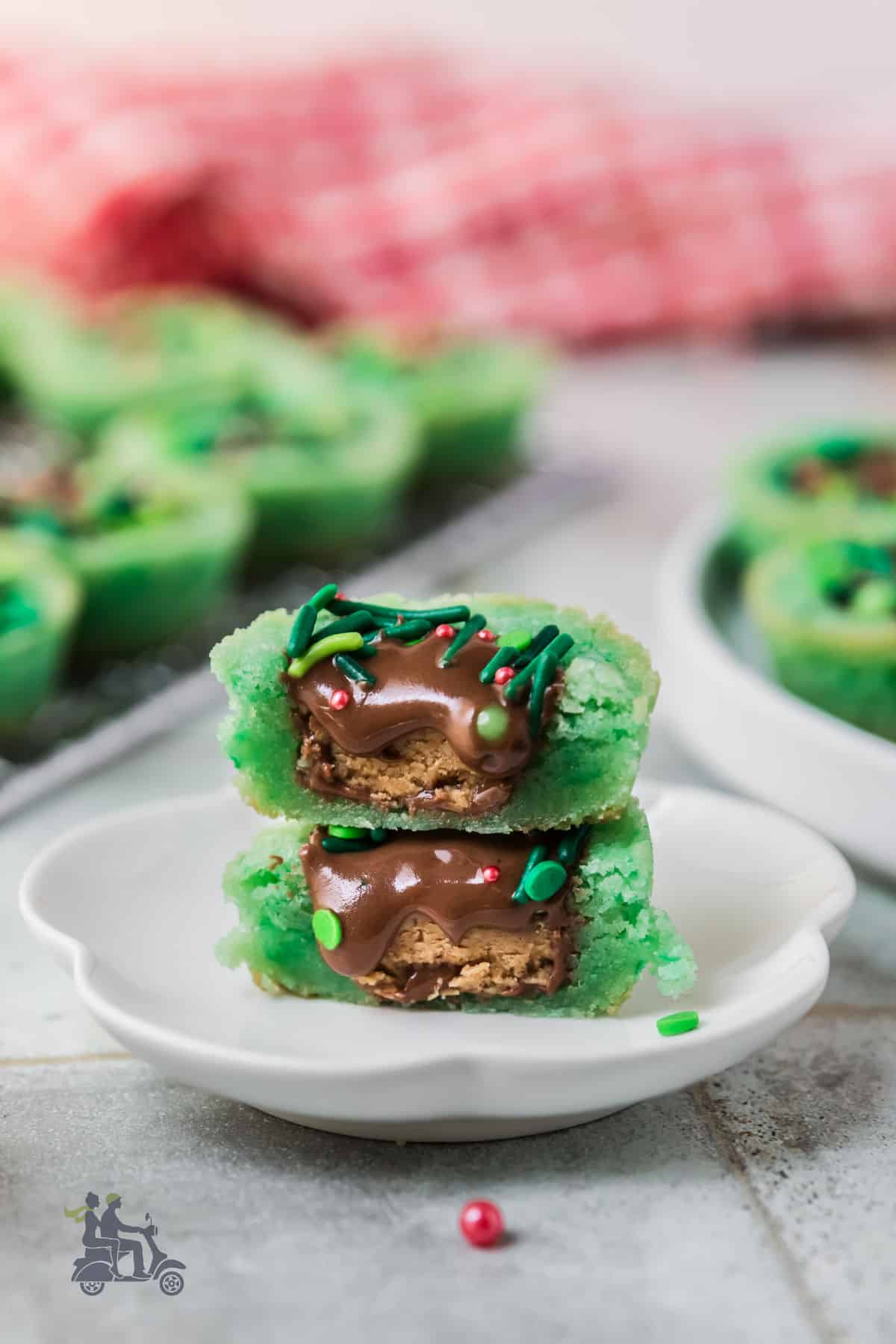 Side view of a halved Sugar cookie wreath filled with a Reese's Peanut Butter Cup. 