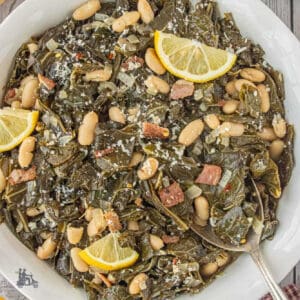 The Tuscan Collard Greens with Pancetta and Cannellini Beans recipe is shown in a white bowl with a serving spoon.