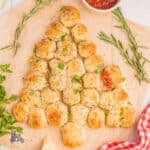 Cheese-stuffed rolls in the shape of a Christmas tree on a cutting board.