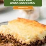 A helping of layered Greek moussaka made with beef and topped with a creamy sauce.
