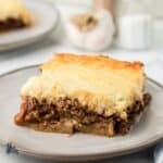 A square of Greek Moussaka casserole on a stonewear plate.
