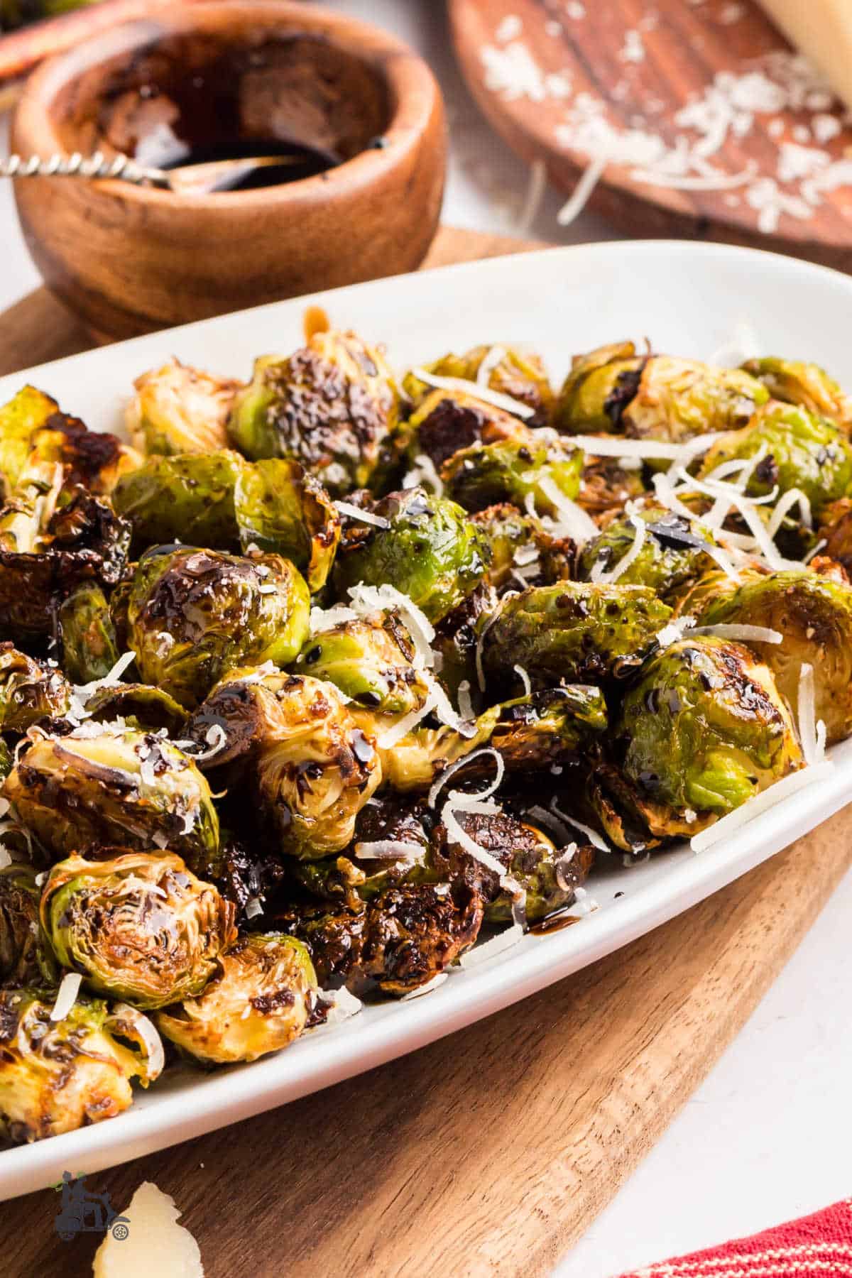 Crispy Brussels sprouts topped with balsamic vinegar glaze and Parmesan cheese. 