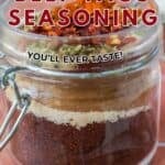 Beef Taco Seasoning in a glass jar with the layers of seasoning visible.