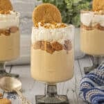 A glass parfait holding creamy butterscotch pudding layered with gingersnap crumbles and topped with whipped cr&egrave;me fra&icirc;che.