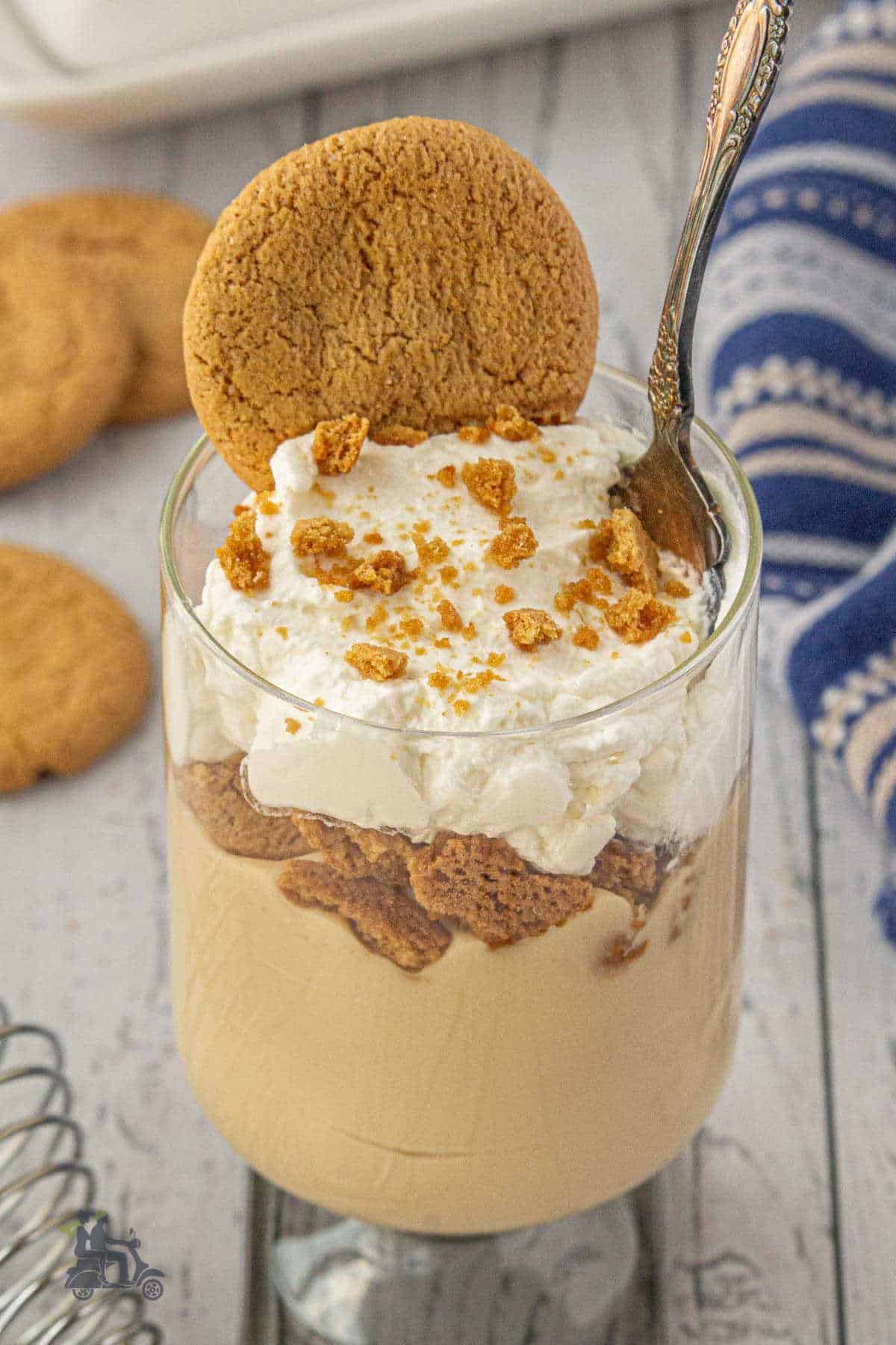 Holiday butterscotch pudding parfait served in a glass with a spoon.