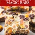 Plate of pistachio and cherry holiday magic bars dusted with orange peel.