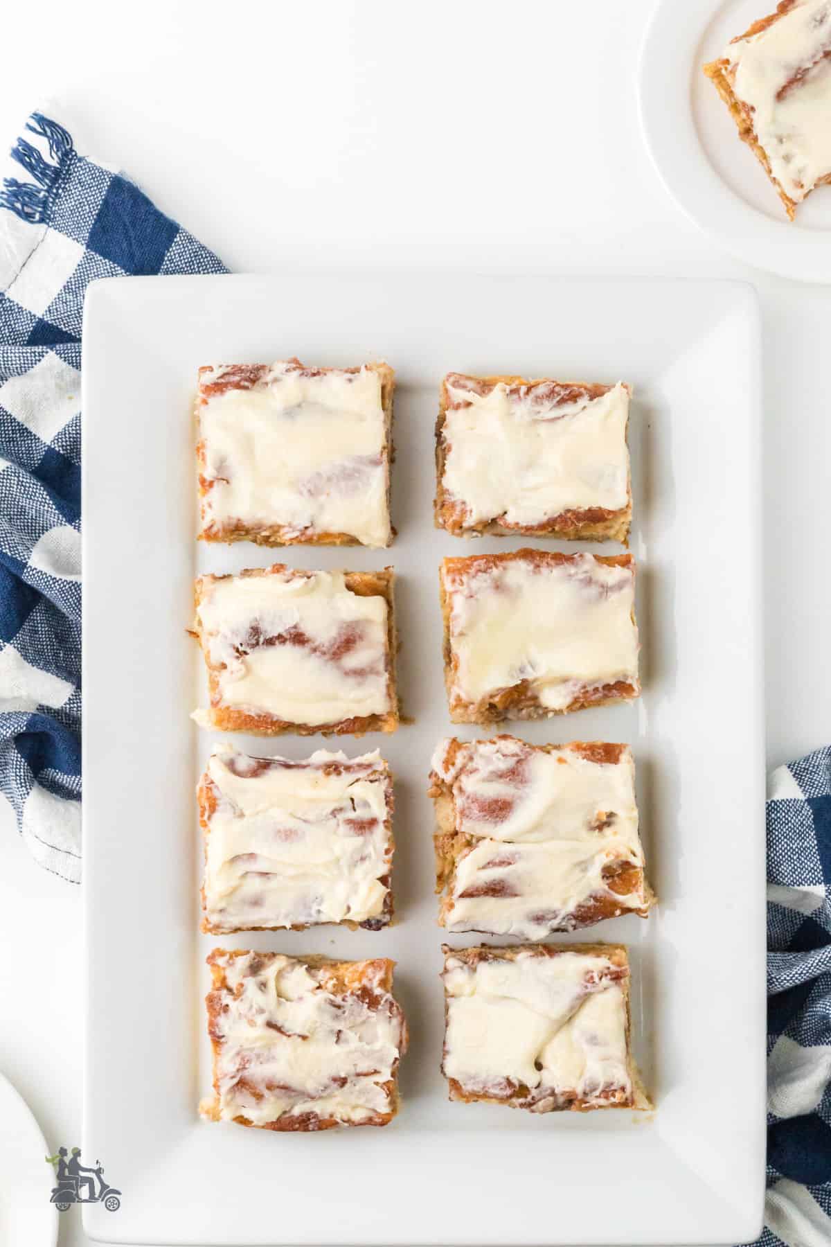 Cinnamon sugar focaccia cut into serving pieces on a white platter. 