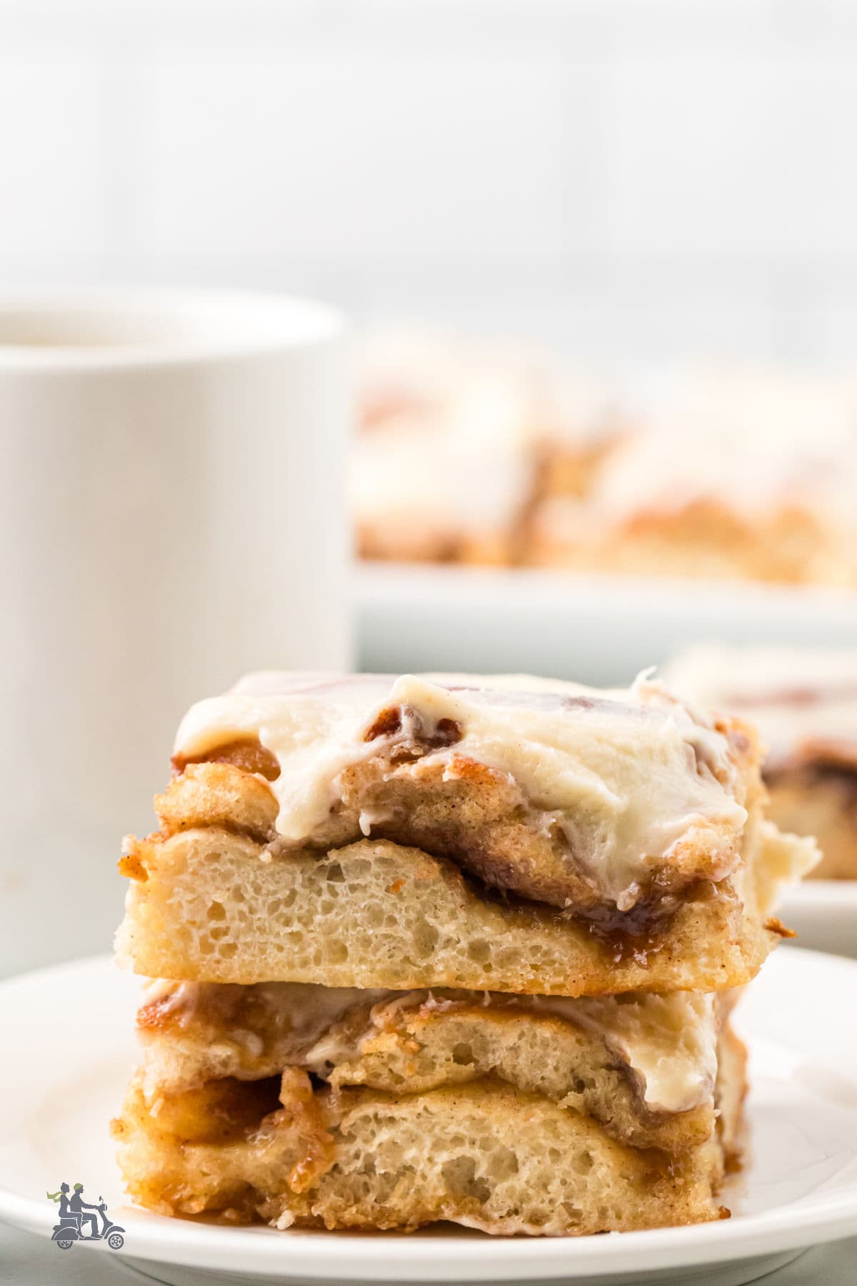 Two dessert squares of sweet focaccia on a white plate. 