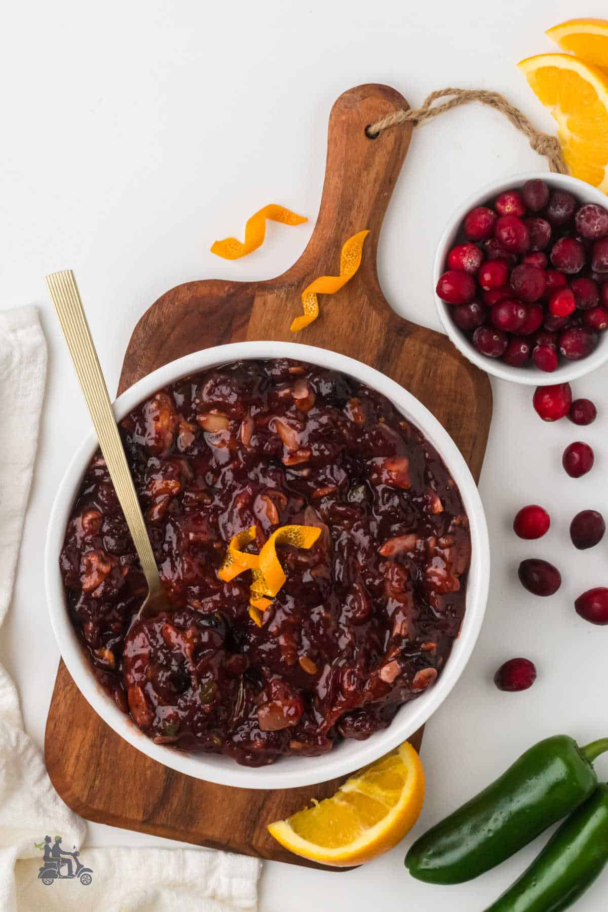 The holiday cranberry side dish is placed on a wooden cutting board.