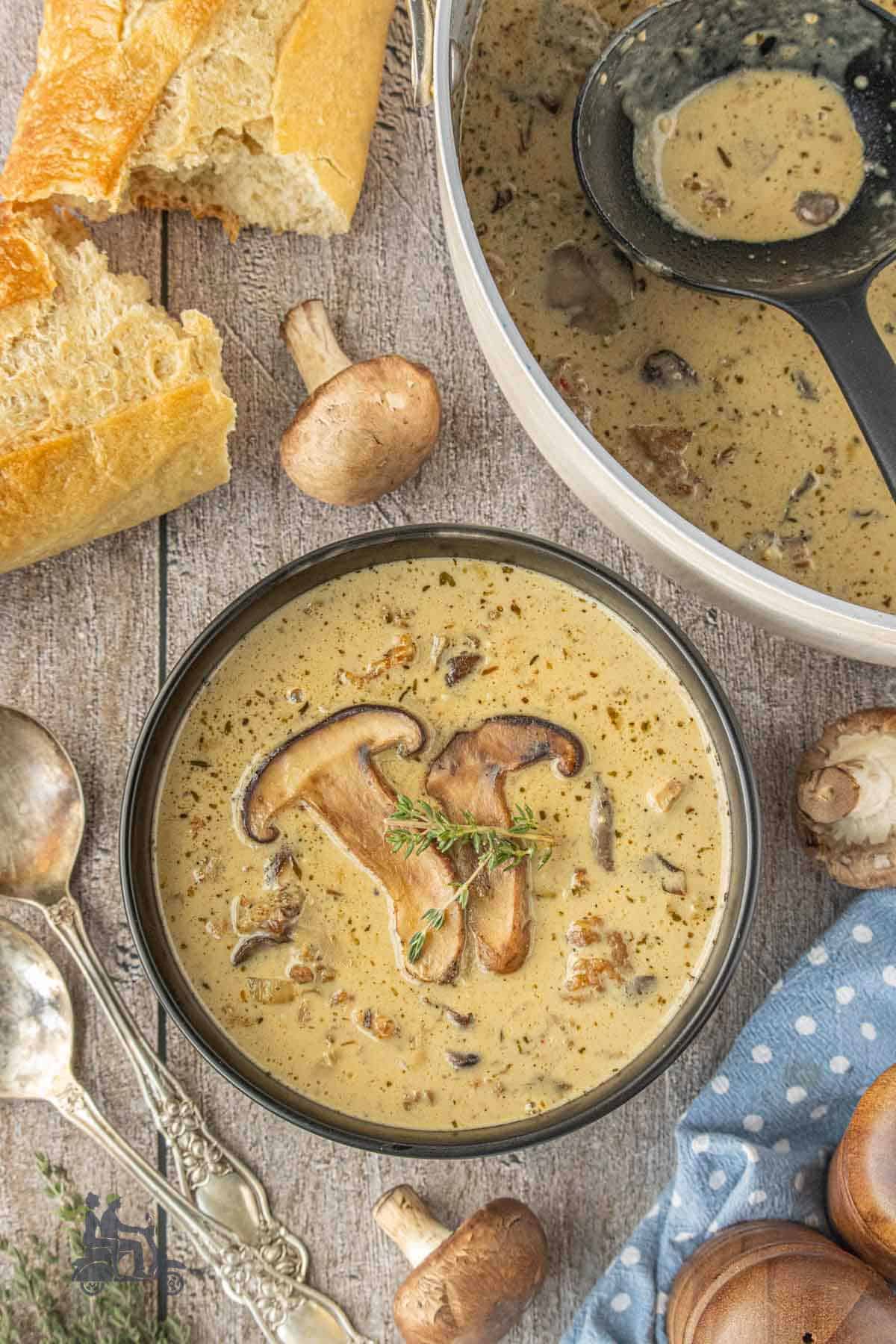 Creamy Italian mushroom soup with sausage in a dark brown bowl.