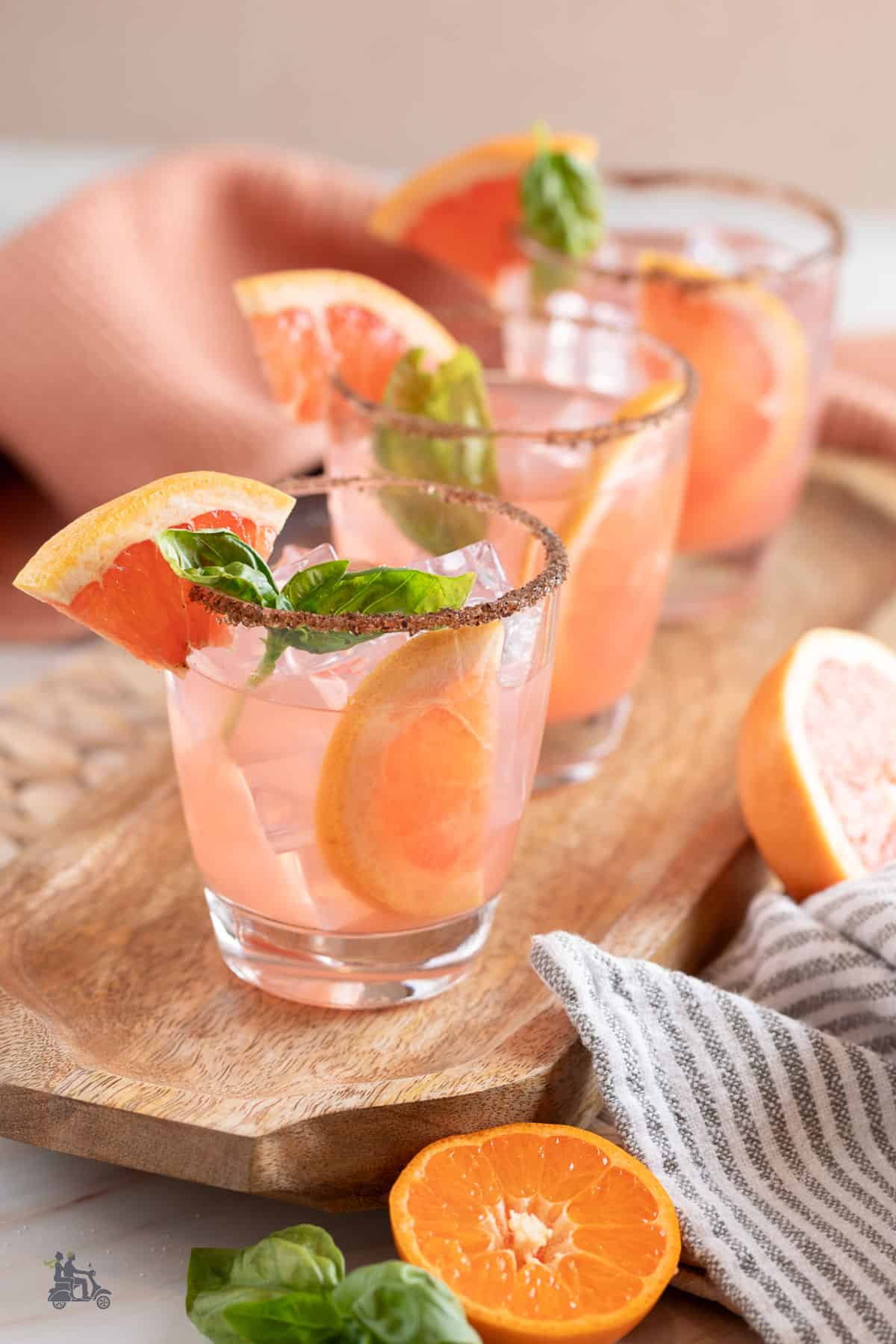 Three tumblers filled with a grapefruit gin cocktail. 