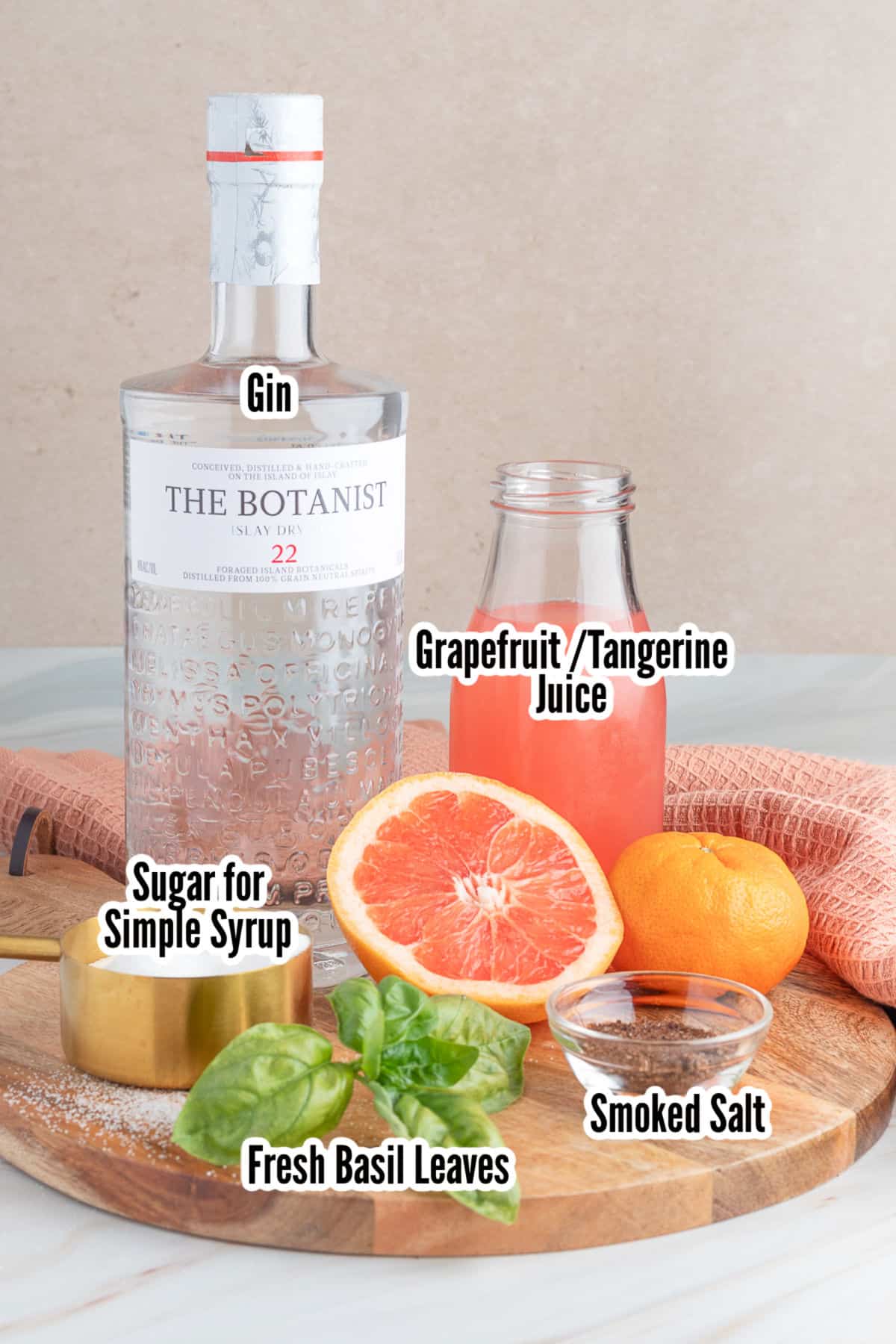 Image of the ingredients needed to make the grapefruit cocktail with tangerine and smoked salt glass rim.
