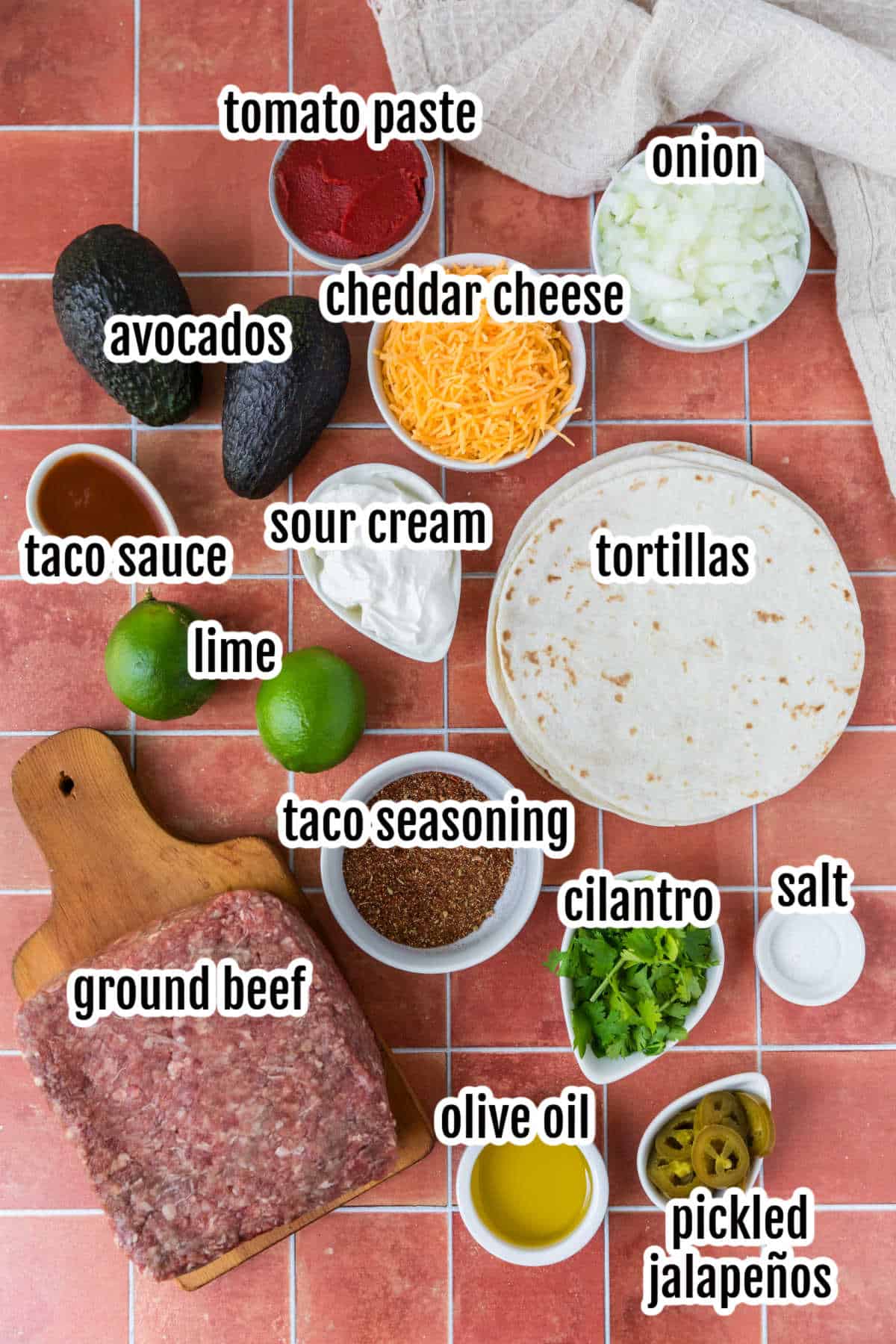 The ingredients needed to make the oven-baked beef tacos and lime cream sauce.