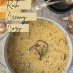 Homemade mushroom soup with sausage and cream in a white Dutch Oven with mushrooms floating on top.