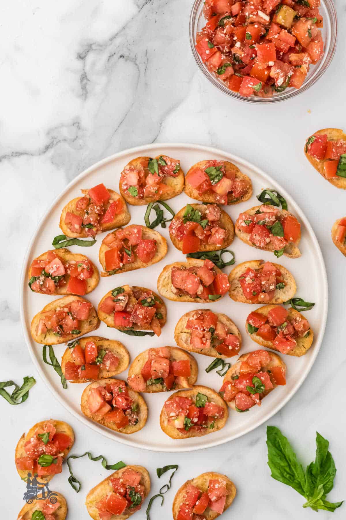 Toasted baguette slices topped with balsamic tomato bruschetta mixture.
