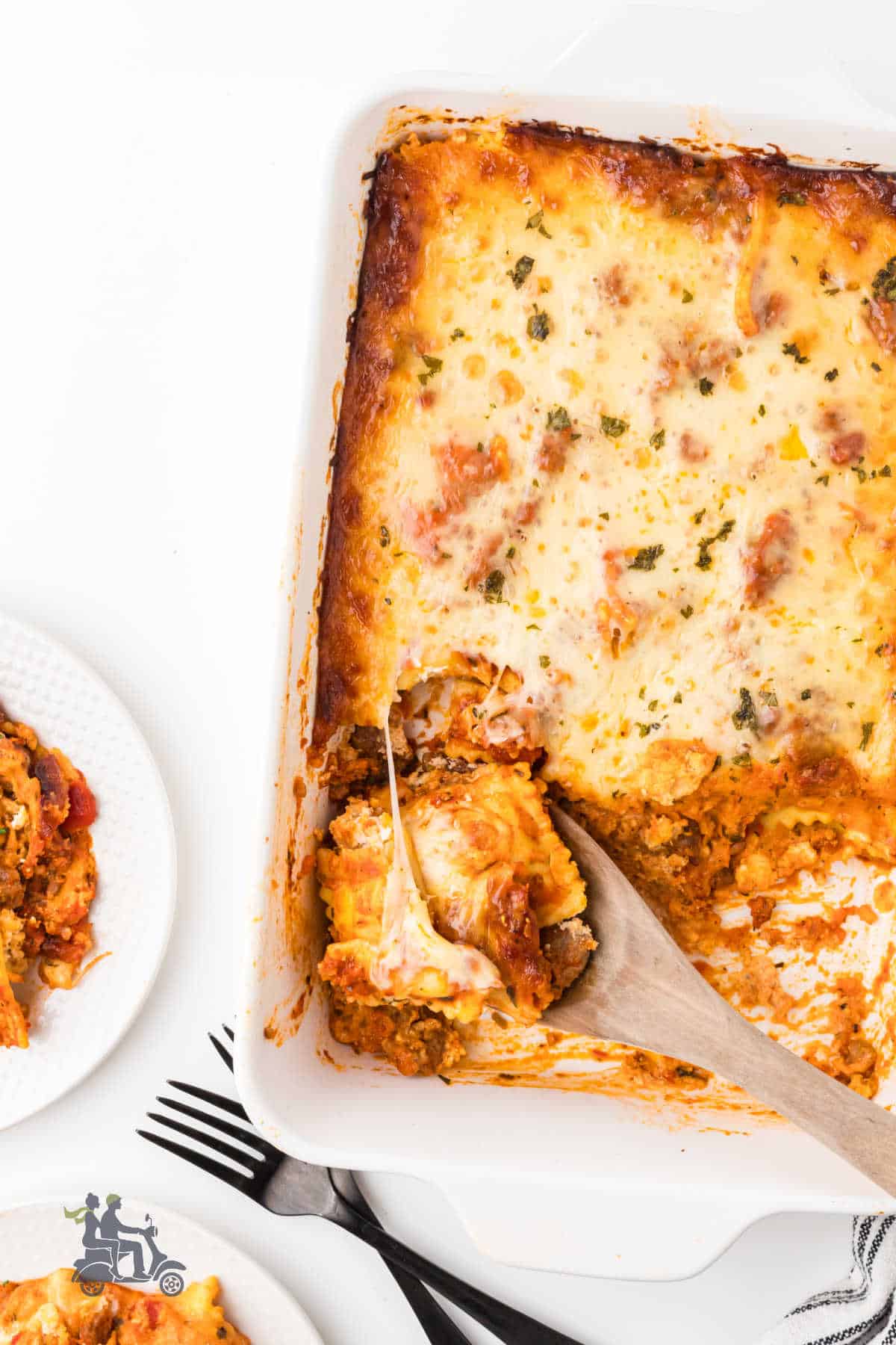 An overhead view of the ravioli casserole with several helpings removed from the dish.