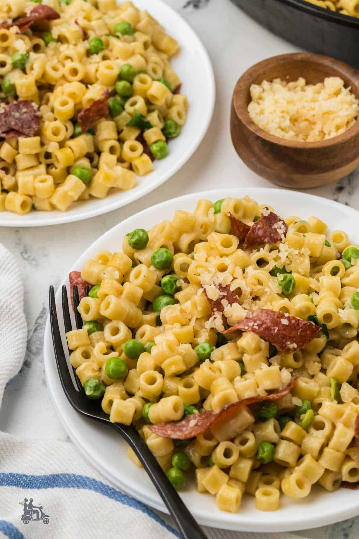 Creamy ditalini and peas pasta finished with lemon zest.