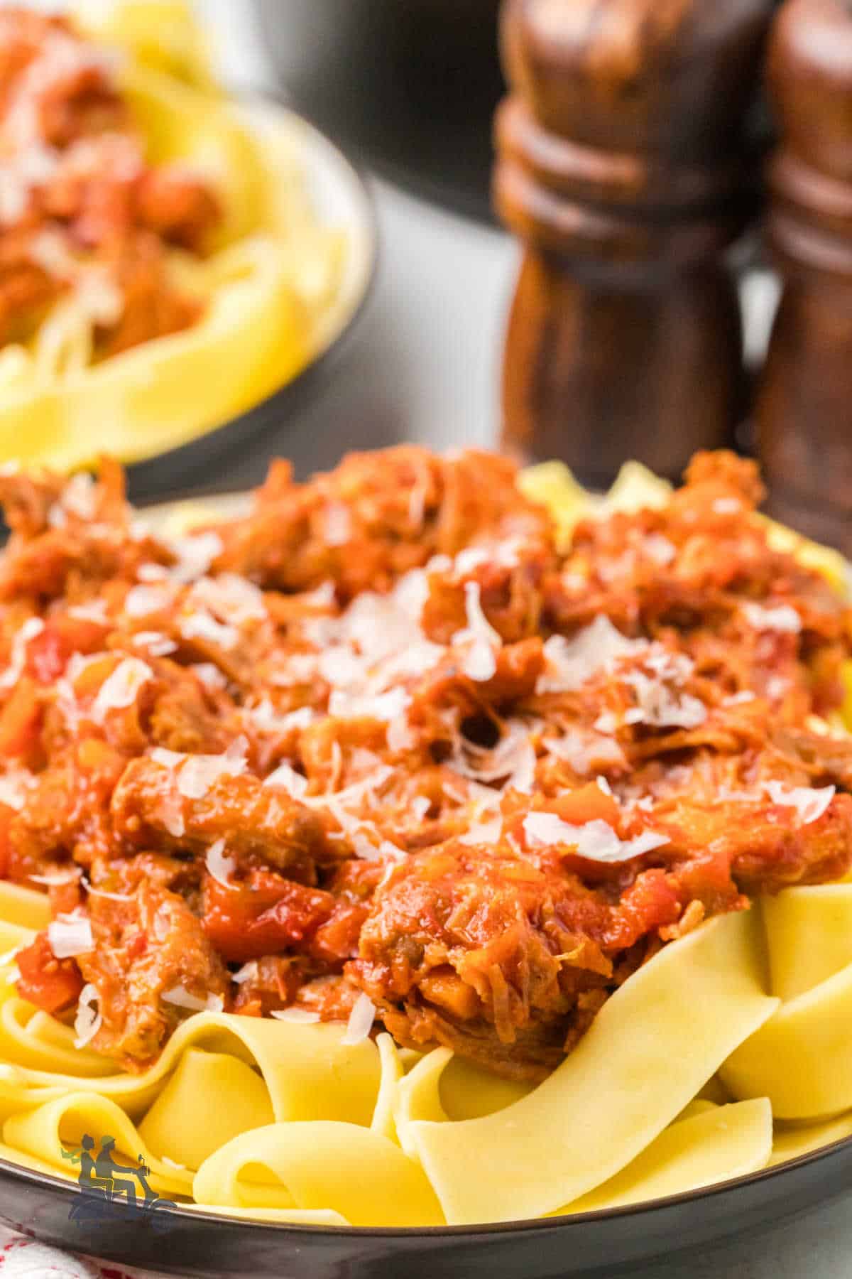Pork shoulder pasta sauce with fresh herbs and tomato sauce over fresh egg pasta.