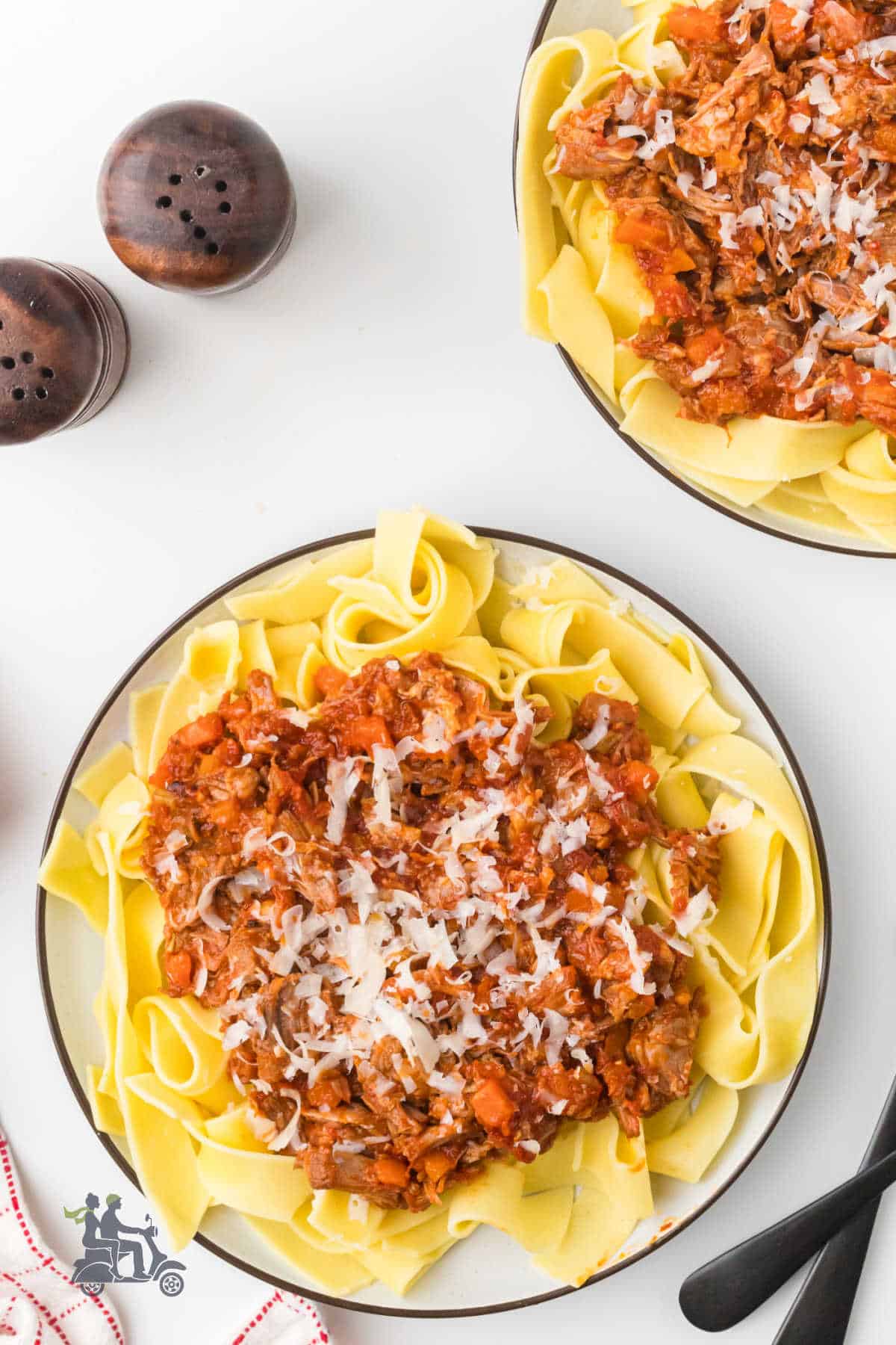 Slow-cooked pork ragù with white wine over pappardelle pasta.